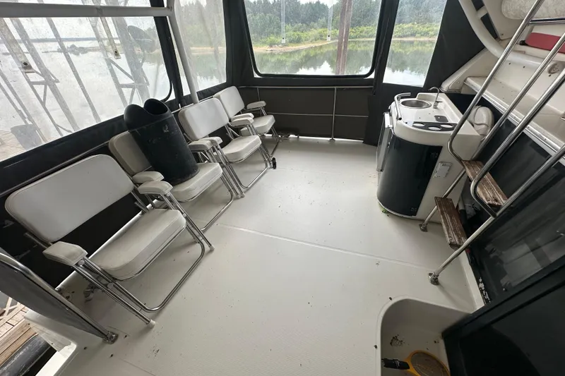 Slide: The Image of 1990 Bayliner 4388 Motoryacht docked under a covered marina. - 3