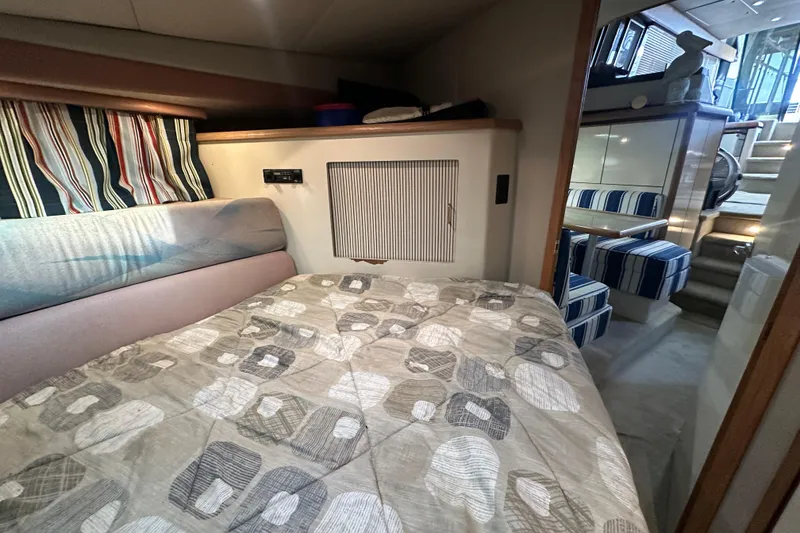 Slide: The Image of 1990 Bayliner 4388 Motoryacht interior cabin with bed and striped decor. - 31