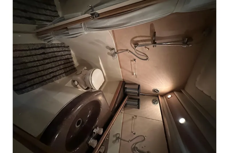 Slide: The Image of 1990 Bayliner 4388 Motoryacht bathroom with sink, toilet, and shower fixtures. - 33