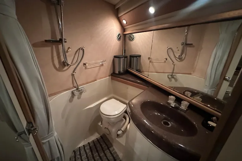 Slide: The Image of 1990 Bayliner 4388 Motoryacht bathroom with shower, sink, and toilet. - 34
