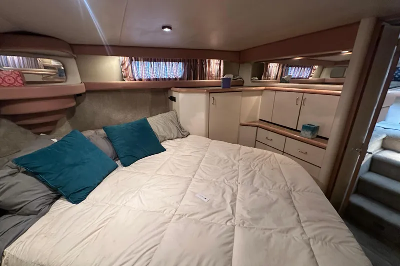 Slide: The Image of Cozy bedroom in 1990 Bayliner 4388 Motoryacht with plush bedding and ample storage. - 37