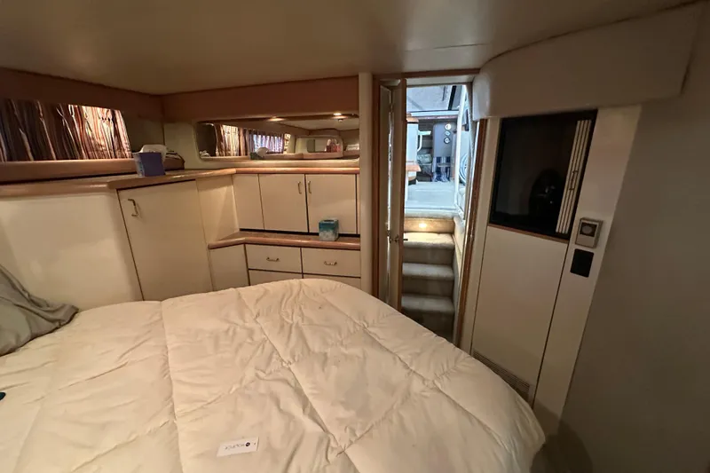 Slide: The Image of Interior of 1990 Bayliner 4388 Motoryacht cabin with bed and storage cabinets. - 38