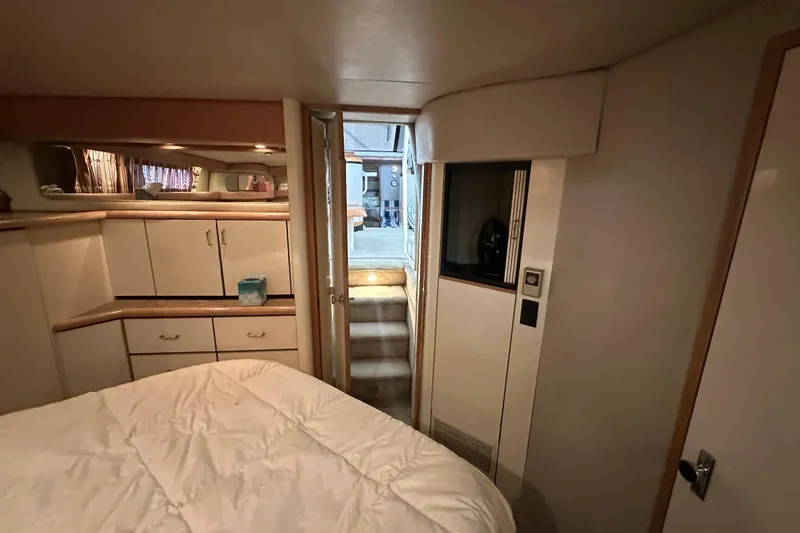 Slide: The Image of Interior cabin of 1990 Bayliner 4388 Motoryacht with cozy bed and storage cabinets. - 42