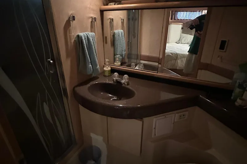 Slide: The Image of Bathroom interior of 1990 Bayliner 4388 Motoryacht with sink, mirror, and towels. - 43