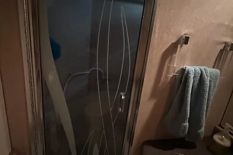 Slide: The Image of Bathroom interior of 1990 Bayliner 4388 Motoryacht with glass shower door and towel rack. - 45