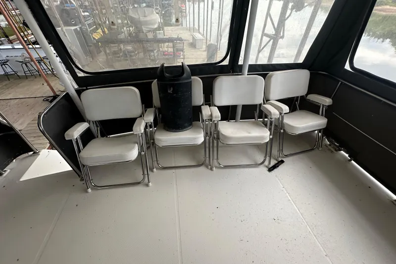 Slide: The Image of 1990 Bayliner 4388 Motoryacht docked, featuring covered deck and "AquaHolic" name. - 6