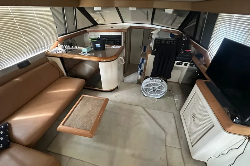 Slide: The Image of 1990 Bayliner 4388 Motoryacht docked under a covered marina with protective canvas. - 7