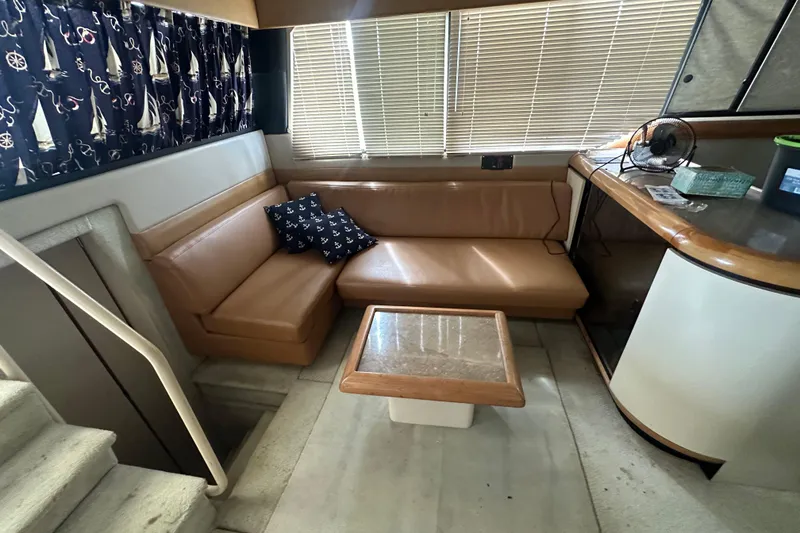 Slide: The Image of 1990 Bayliner 4388 Motoryacht docked under a covered marina, side view. - 8