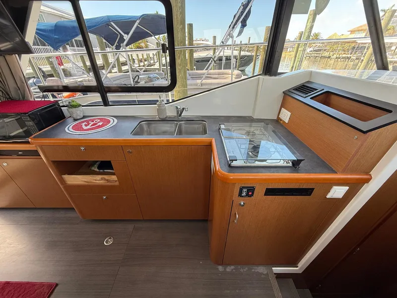 Slide: The Image of Interior view of 2016 Beneteau Swift Trawler 30 with a comfortable bed setup. - 17