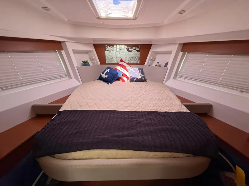 Slide: The Image of 2016 Beneteau Swift Trawler 30 kitchen with sink, stove, and wooden cabinetry. - 18