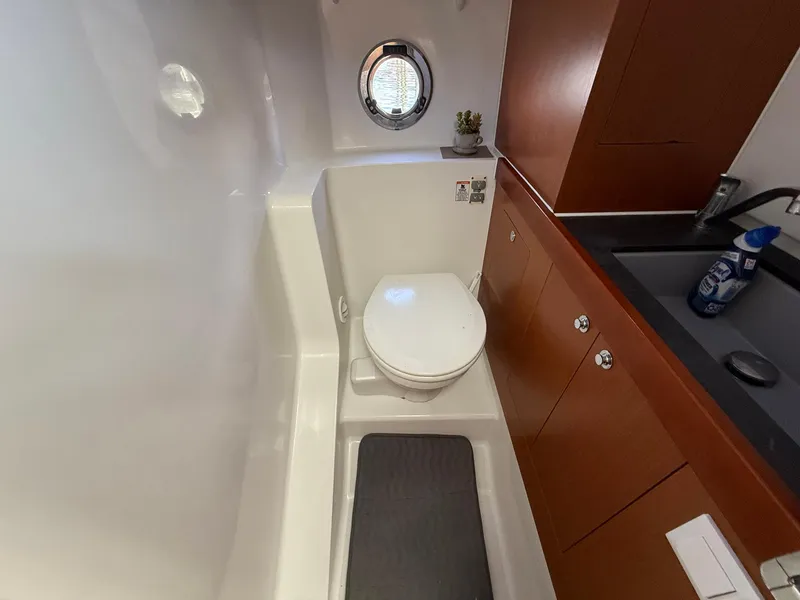 Slide: The Image of 2016 Beneteau Swift Trawler 30 interior cabin with cozy bed and nautical decor. - 19