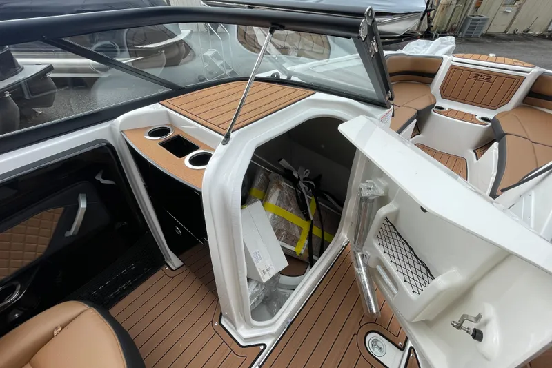 Slide: The Image of 2026 Yamaha Boats 252SD interior with storage compartment and seating area. - 10
