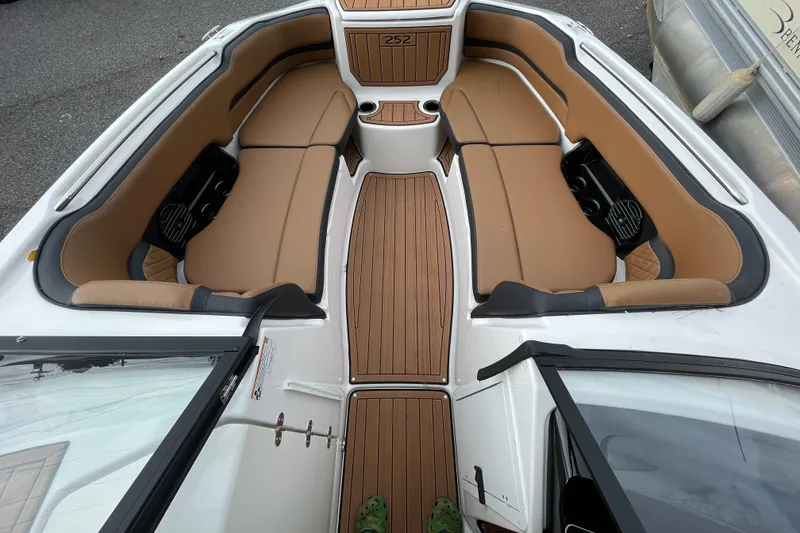 Slide: The Image of 2026 Yamaha Boats 252SD interior with tan seating and wood-style flooring. - 12