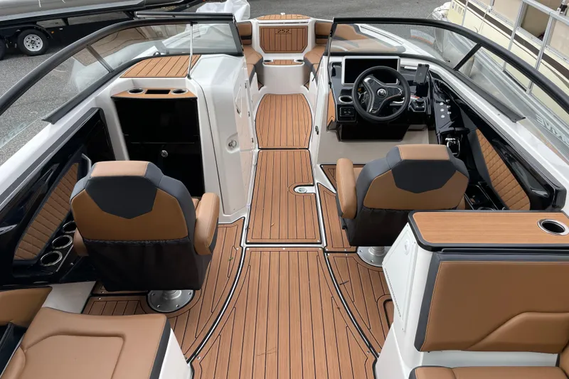 Slide: The Image of 2026 Yamaha Boats 252SD interior with sleek design, tan and black seating, and modern dashboard. - 13