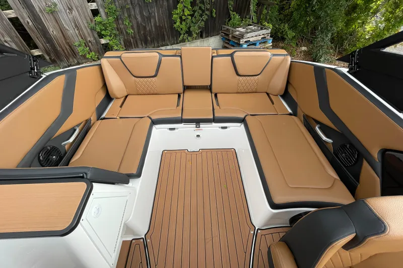 Slide: The Image of Luxurious interior of 2026 Yamaha Boats 252SD with tan seating and wood-style flooring. - 14