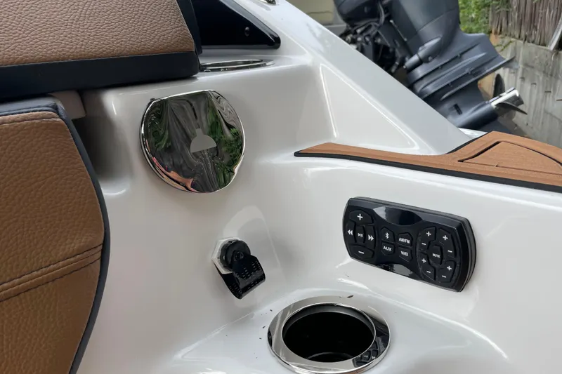 Slide: The Image of 2026 Yamaha Boats 252SD interior with control panel, cup holder, and brown leather accents. - 15