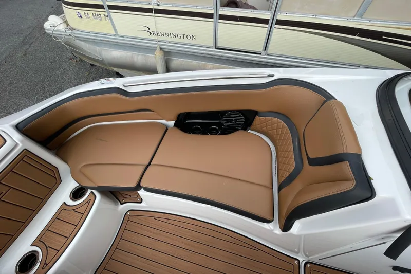 Slide: The Image of 2026 Yamaha Boats 252SD interior with tan seating and wood-style flooring. - 18