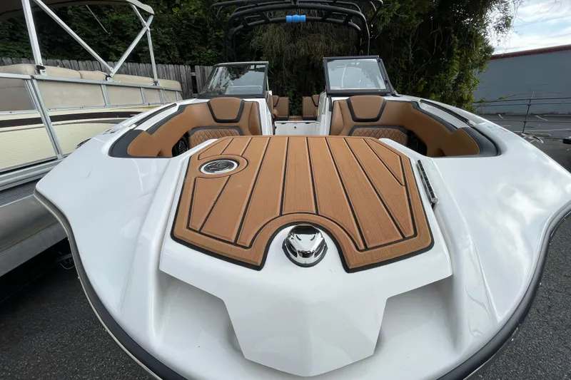 Slide: The Image of 2026 Yamaha Boats 252SD, sleek design with wood accents, docked outdoors. - 6