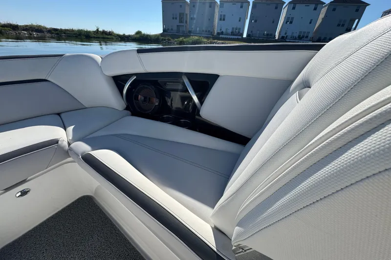 Slide: The Image of 2018 MasterCraft XStar interior with white seating, speaker, and modern design elements. - 11