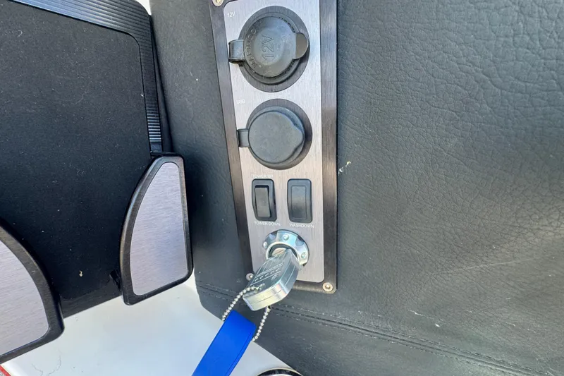 Slide: The Image of Control panel of 2018 MasterCraft XStar boat with key and switches. - 18