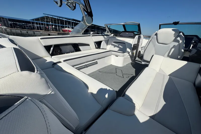 Slide: The Image of 2018 MasterCraft XStar boat interior with luxurious white seating and modern design. - 25