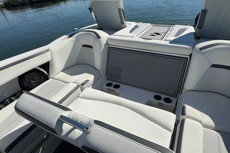 Slide: The Image of 2018 MasterCraft XStar boat interior with luxurious seating and cup holders. - 36