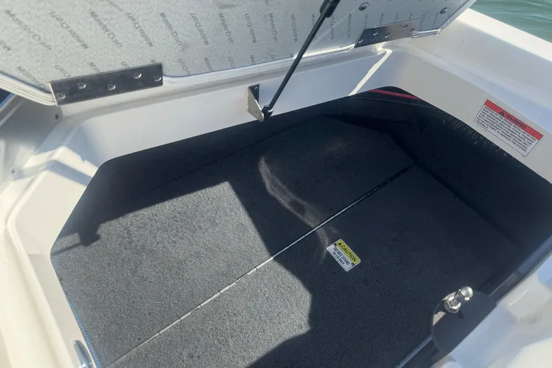 Slide: The Image of Open storage compartment of 2018 MasterCraft XStar boat, showing interior details. - 40