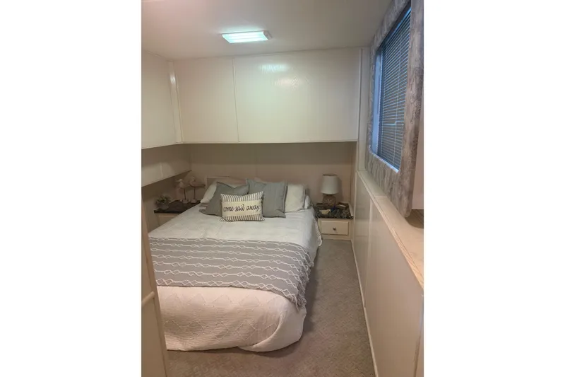 Slide: The Image of Cozy bedroom in 2001 Fantasy houseboat with nautical decor and soft lighting. - 11