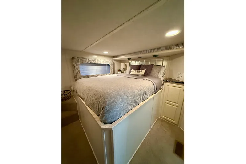 Slide: The Image of Cozy bedroom interior in 2001 Fantasy houseboat with elegant bedding and soft lighting. - 13