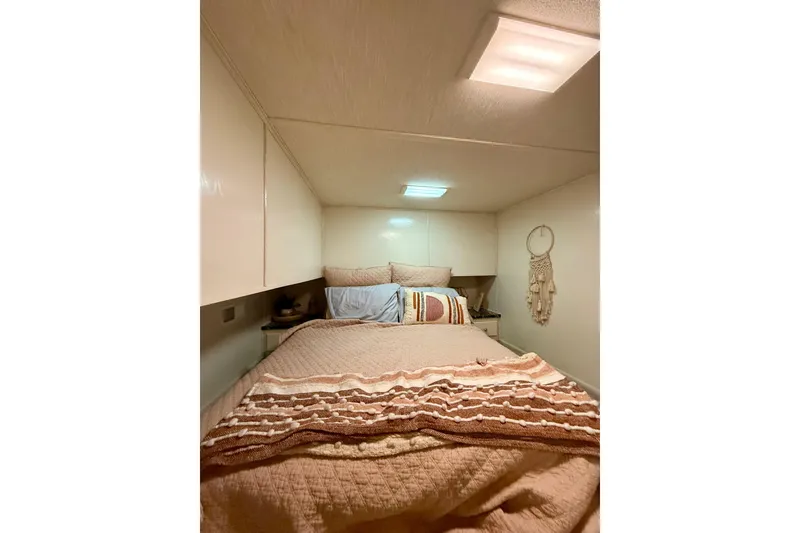 Slide: The Image of Cozy bedroom interior in 2001 Fantasy houseboat with warm bedding and wall decor. - 16