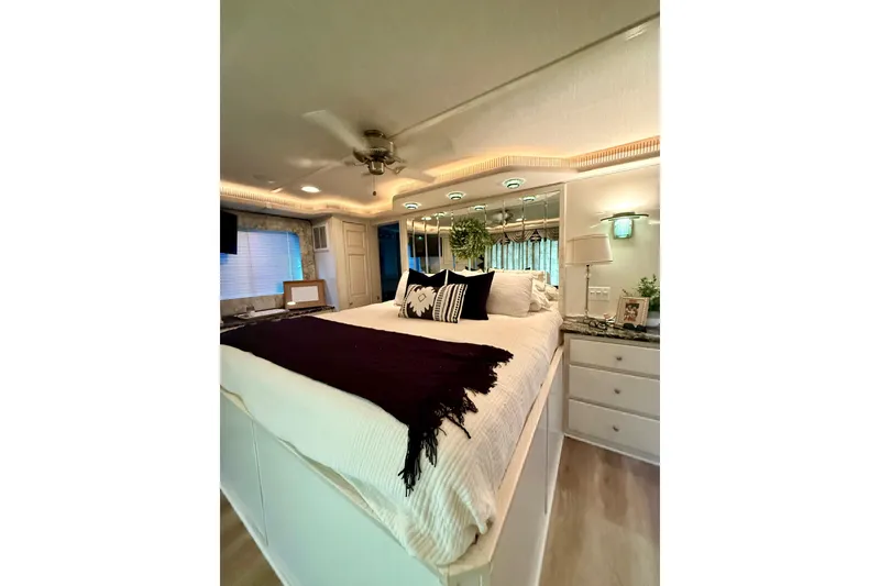 Slide: The Image of Luxurious bedroom interior in a 2001 Fantasy houseboat, featuring elegant decor and ambient lighting. - 18