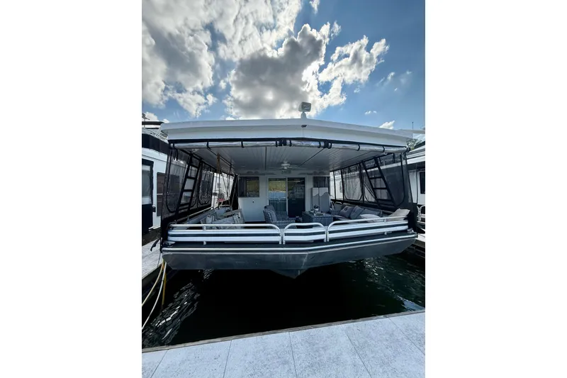 Slide: The Image of Fantasy 2001 houseboat docked under a partly cloudy sky. - 2