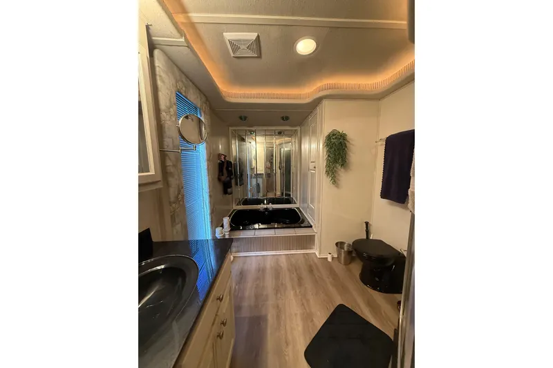 Slide: The Image of Luxurious bathroom in a 2001 Fantasy houseboat with modern fixtures and elegant lighting. - 20