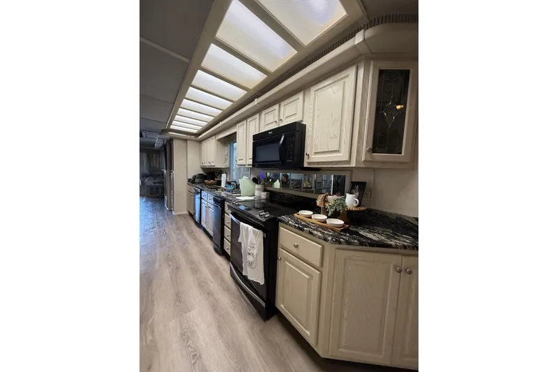 Slide: The Image of Modern kitchen interior in 2001 Fantasy Houseboat with sleek appliances and elegant cabinetry. - 9