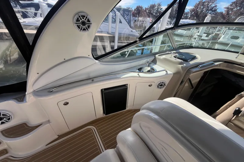 Slide: The Image of Interior of 2002 Sea Ray 300 Sundancer boat with seating and helm area. - 10