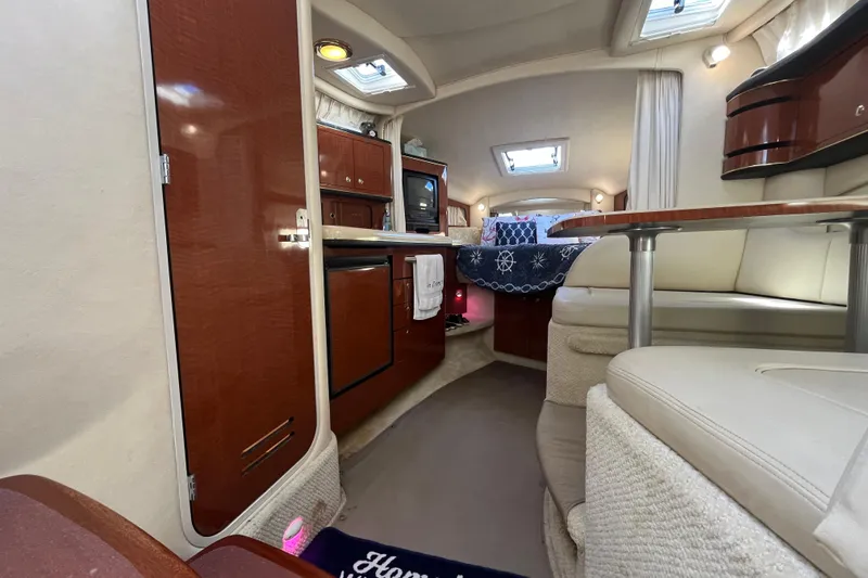 Slide: The Image of Luxurious interior of 2002 Sea Ray 300 Sundancer yacht with cozy seating and elegant wood finishes. - 17