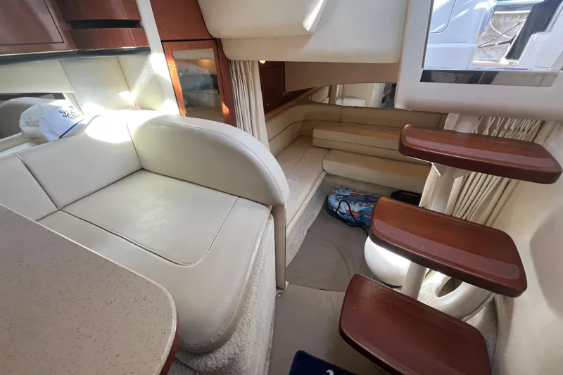 Slide: The Image of Interior of 2002 Sea Ray 300 Sundancer yacht with beige seating and wooden steps. - 18