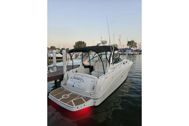 Slide: The Image of 2002 Sea Ray 300 Sundancer docked at marina, evening view. - 2