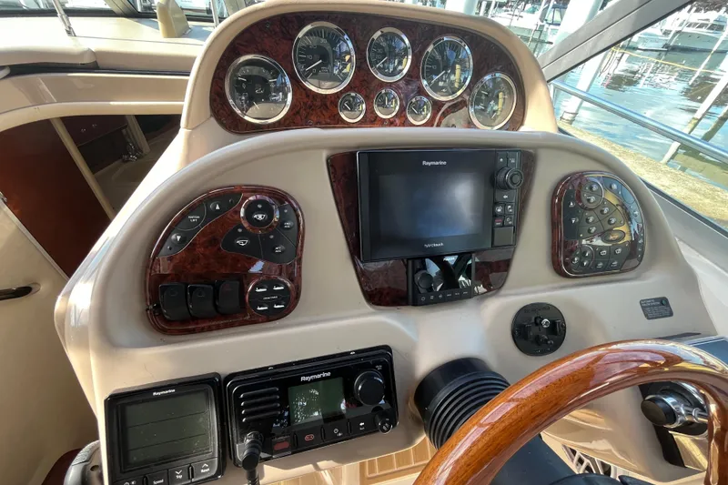 Slide: The Image of Control panel of a 2002 Sea Ray 300 Sundancer boat with navigation instruments. - 7