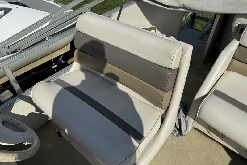 Slide: The Image of AquaPatio 240 RS 2001 boat interior with beige seating and steering wheel. - 11