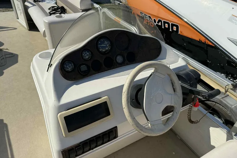 Slide: The Image of Steering console of a 2001 AquaPatio 240 RS boat with gauges and controls. - 12