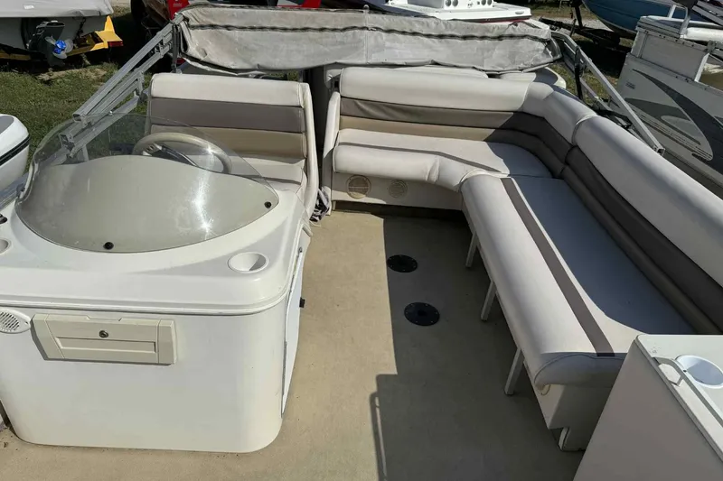 Slide: The Image of 2001 AquaPatio 240 RS boat interior with spacious seating and helm. - 9