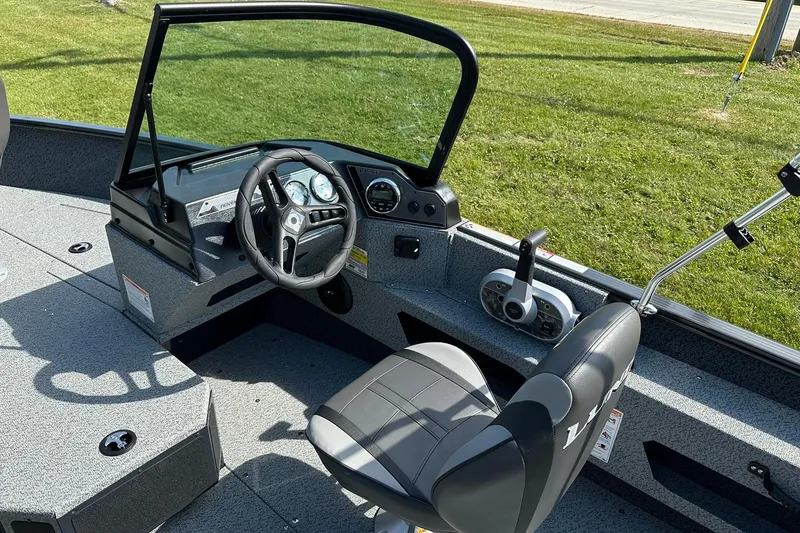 Slide: The Image of 2026 Lund 1775 Adventure Sport boat interior with dual seats and storage compartment. - 10