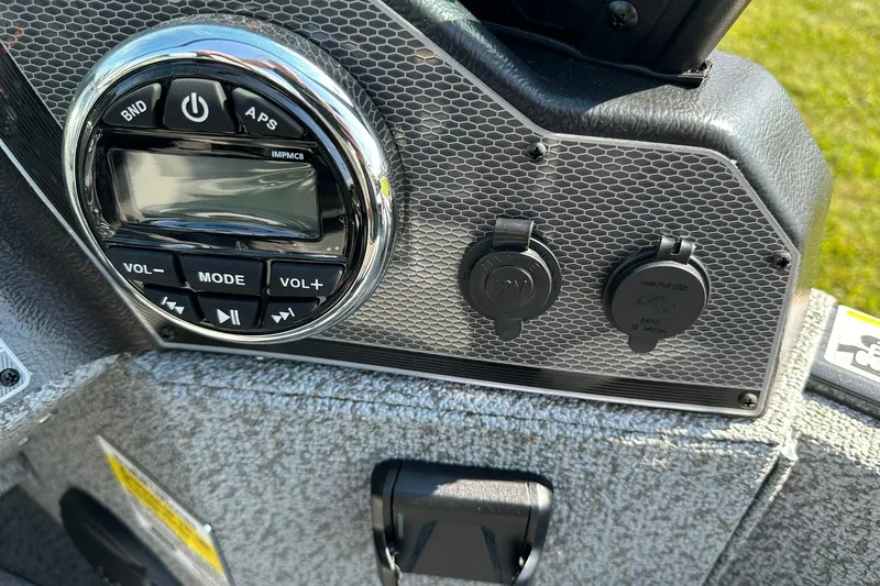 Slide: The Image of 2026 Lund 1775 Adventure Sport boat interior with motor, gray deck, and storage compartments. - 12