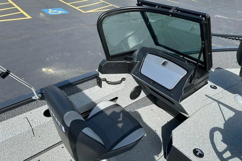 Slide: The Image of 2026 Lund 1775 Adventure Sport boat interior with gray seating and carpeted deck. - 16