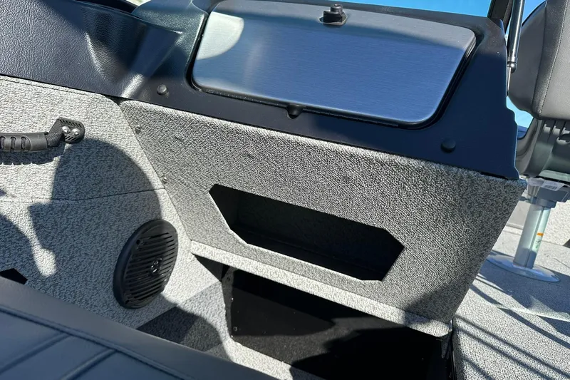 Slide: The Image of Interior of 2026 Lund 1775 Adventure Sport boat, featuring storage and speaker. - 22