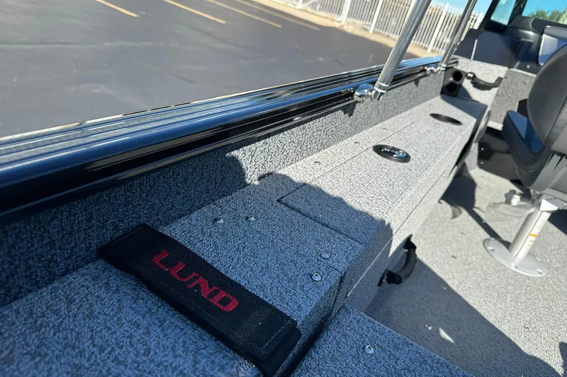 Slide: The Image of 2026 Lund 1775 Adventure Sport interior with gray textured flooring and seating. - 25