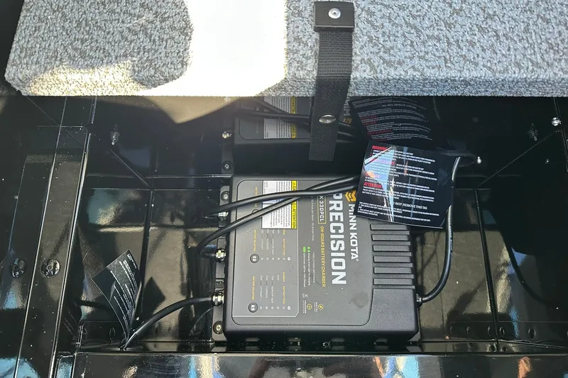 Slide: The Image of Minn Kota Precision charger in 2026 Lund 1775 Adventure Sport boat compartment. - 26