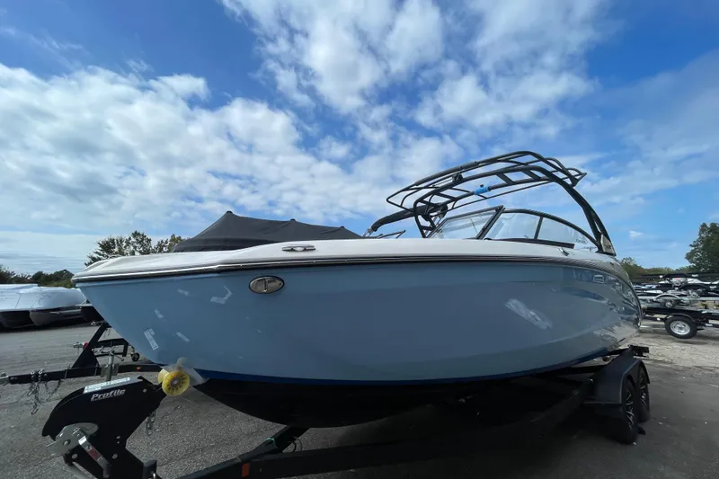 The Image of 2026 Yamaha Boats 252SD on trailer under blue sky, showcasing sleek design. - 0
