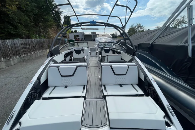 Slide: The Image of 2026 Yamaha Boats 252SD with sleek design and spacious seating, docked outdoors. - 11